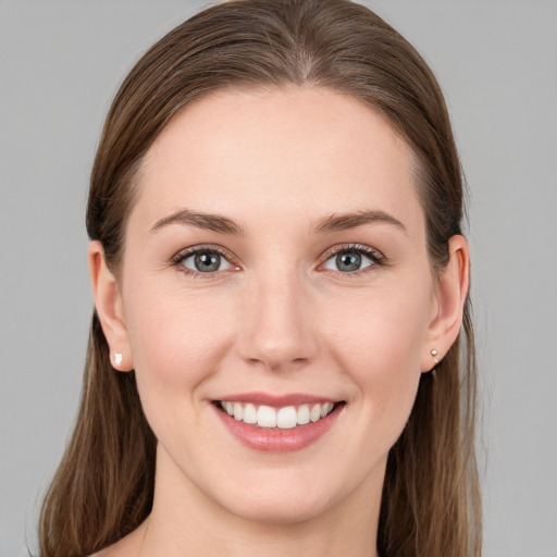 Joyful white young-adult female with long  brown hair and grey eyes