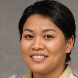 Joyful asian young-adult female with medium  brown hair and brown eyes