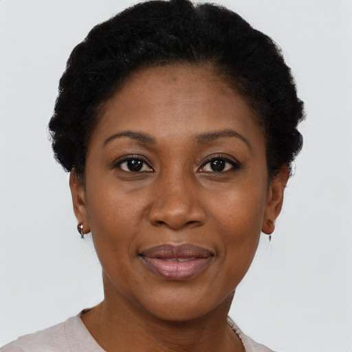 Joyful black adult female with short  black hair and brown eyes