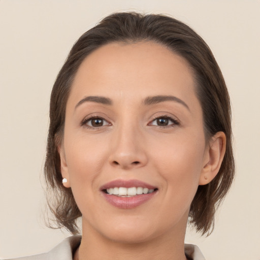 Joyful white young-adult female with medium  brown hair and brown eyes