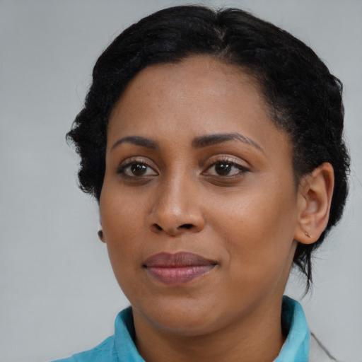 Joyful black young-adult female with medium  brown hair and brown eyes