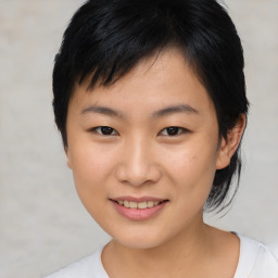 Joyful asian young-adult female with short  black hair and brown eyes