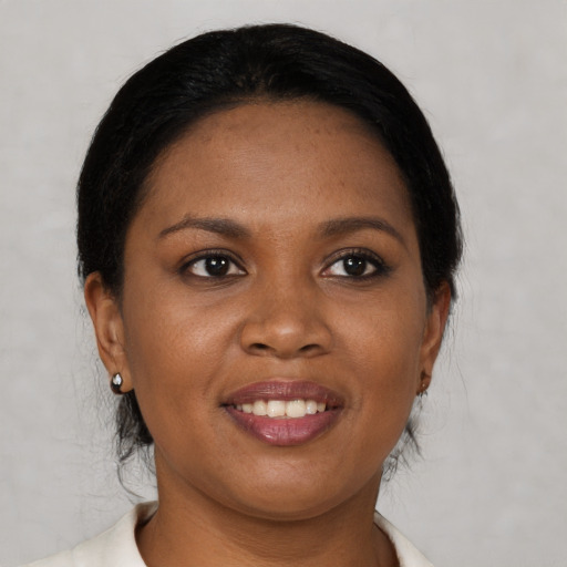 Joyful black young-adult female with medium  brown hair and brown eyes