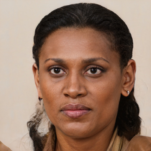 Joyful black adult female with short  brown hair and brown eyes