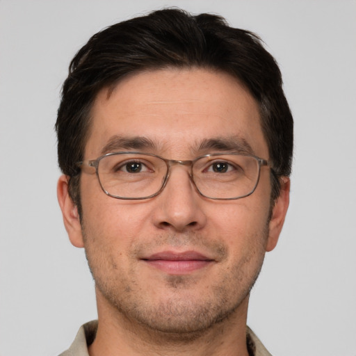 Joyful white adult male with short  brown hair and brown eyes