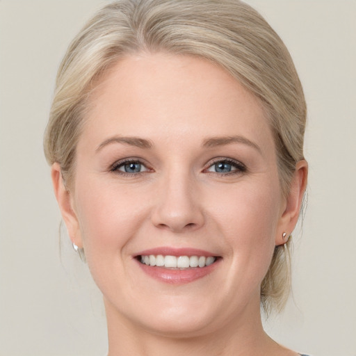 Joyful white young-adult female with medium  blond hair and blue eyes