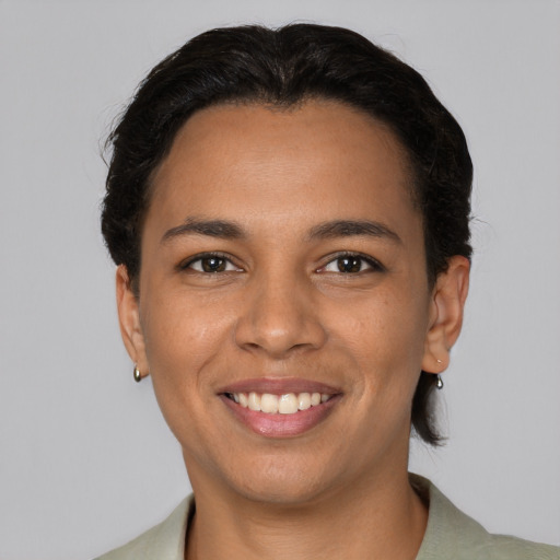 Joyful latino young-adult female with short  brown hair and brown eyes