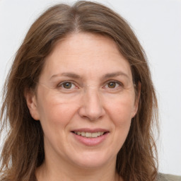 Joyful white adult female with long  brown hair and grey eyes