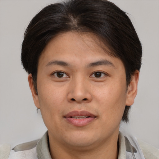 Joyful asian adult female with short  brown hair and brown eyes