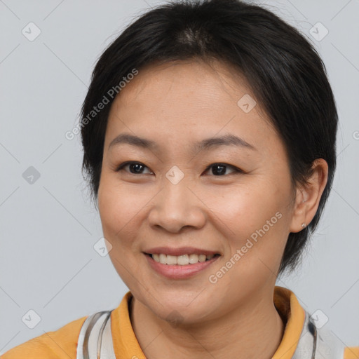 Joyful asian adult female with medium  brown hair and brown eyes