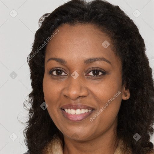 Joyful black young-adult female with long  brown hair and brown eyes