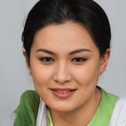 Joyful asian young-adult female with medium  brown hair and brown eyes