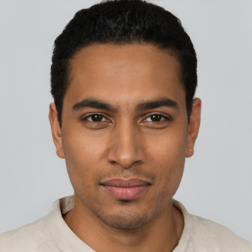 Joyful black young-adult male with short  black hair and brown eyes