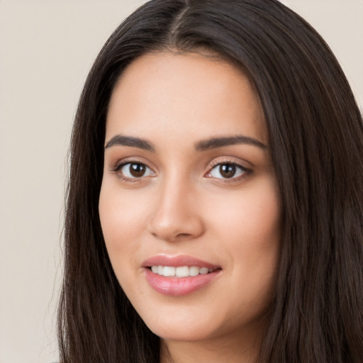 Joyful white young-adult female with long  black hair and brown eyes