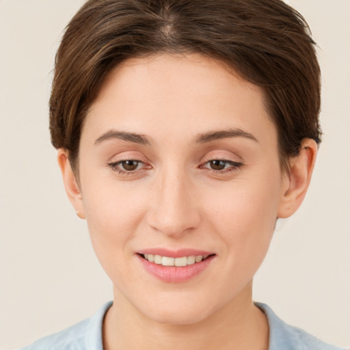 Joyful white young-adult female with short  brown hair and brown eyes