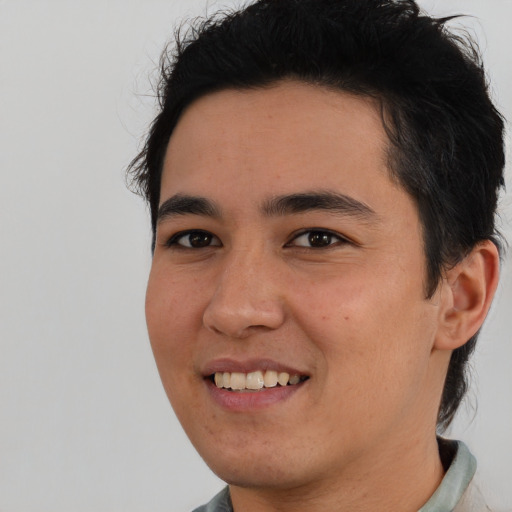 Joyful asian young-adult male with short  black hair and brown eyes
