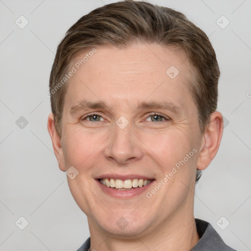 Joyful white adult male with short  brown hair and grey eyes