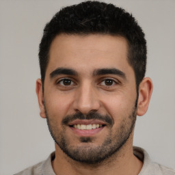 Joyful white young-adult male with short  black hair and brown eyes