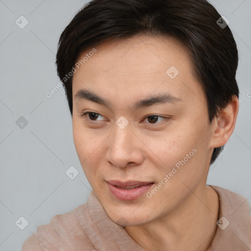 Joyful asian young-adult male with short  brown hair and brown eyes