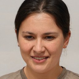 Joyful white adult female with medium  brown hair and brown eyes