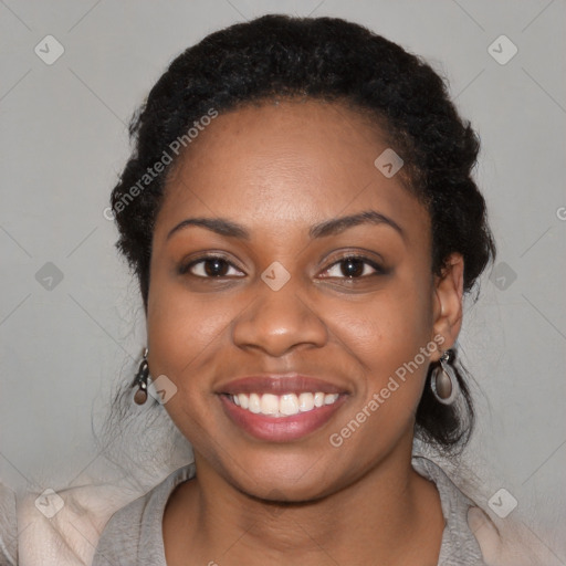 Joyful black young-adult female with medium  black hair and brown eyes