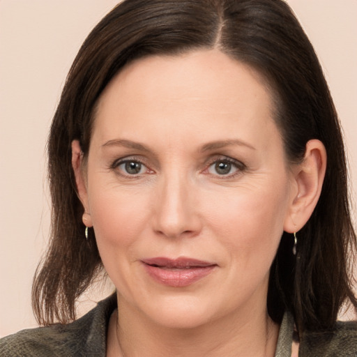 Joyful white adult female with medium  brown hair and brown eyes