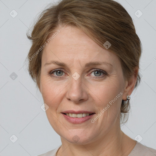 Joyful white adult female with medium  brown hair and grey eyes