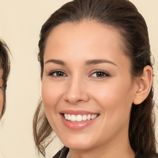 Joyful white young-adult female with long  brown hair and brown eyes