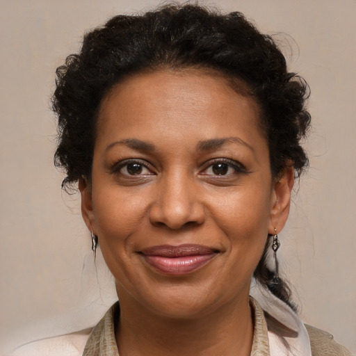 Joyful black adult female with medium  brown hair and brown eyes