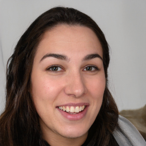 Joyful white young-adult female with long  brown hair and brown eyes