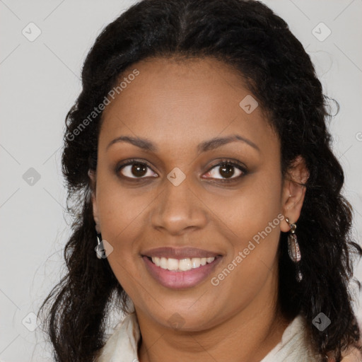 Joyful black young-adult female with long  brown hair and brown eyes
