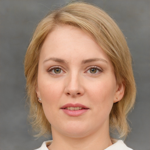 Joyful white young-adult female with medium  brown hair and blue eyes