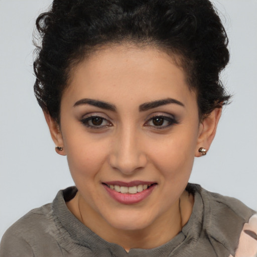 Joyful latino young-adult female with short  brown hair and brown eyes