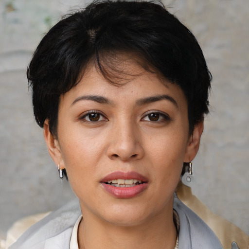 Joyful white young-adult female with short  black hair and brown eyes