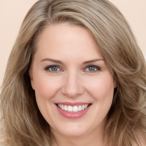 Joyful white young-adult female with long  brown hair and green eyes