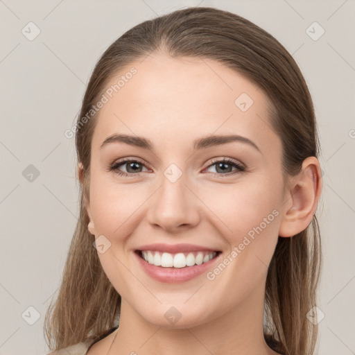 Joyful white young-adult female with long  brown hair and grey eyes