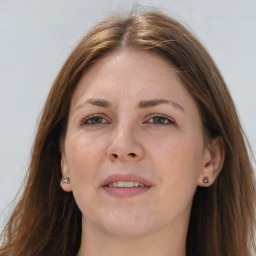 Joyful white adult female with long  brown hair and grey eyes