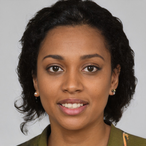 Joyful black young-adult female with medium  brown hair and brown eyes