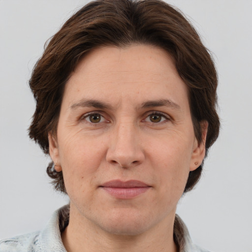 Joyful white adult female with short  brown hair and grey eyes