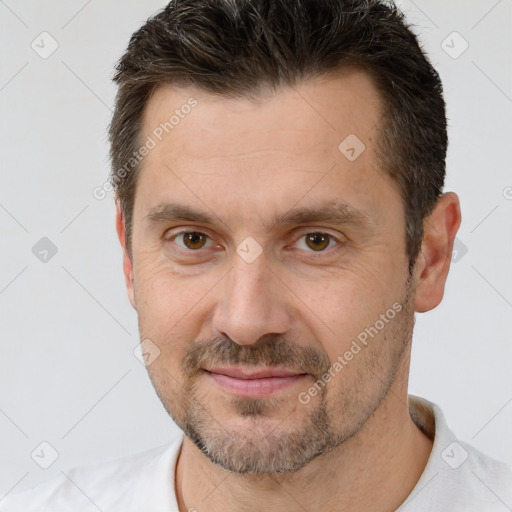 Joyful white adult male with short  brown hair and brown eyes