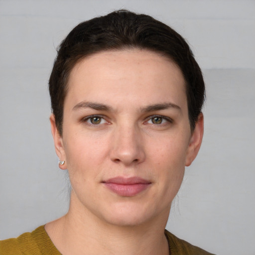 Joyful white young-adult female with short  brown hair and grey eyes