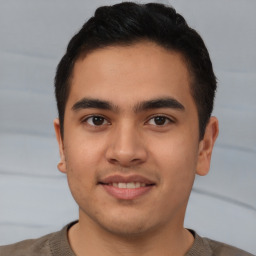 Joyful latino young-adult male with short  brown hair and brown eyes