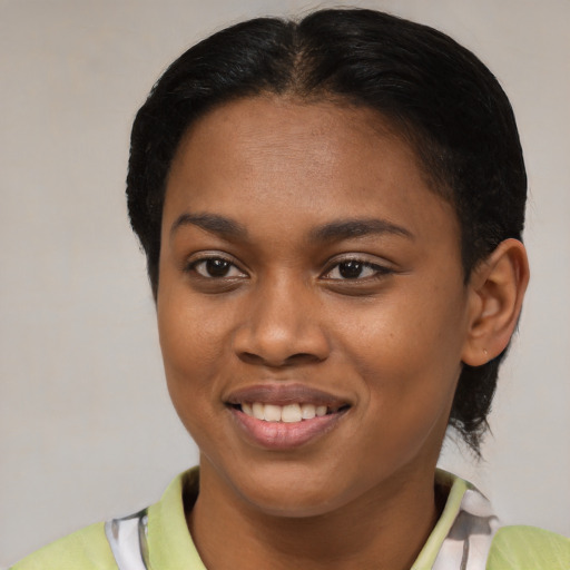 Joyful latino young-adult female with short  brown hair and brown eyes