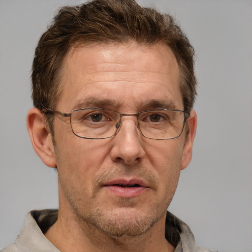 Neutral white middle-aged male with short  brown hair and grey eyes