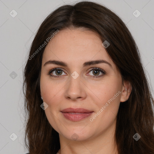 Joyful white adult female with long  brown hair and brown eyes