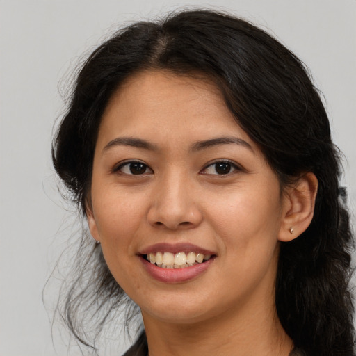 Joyful latino young-adult female with long  brown hair and brown eyes