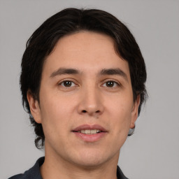 Joyful white young-adult male with medium  brown hair and brown eyes