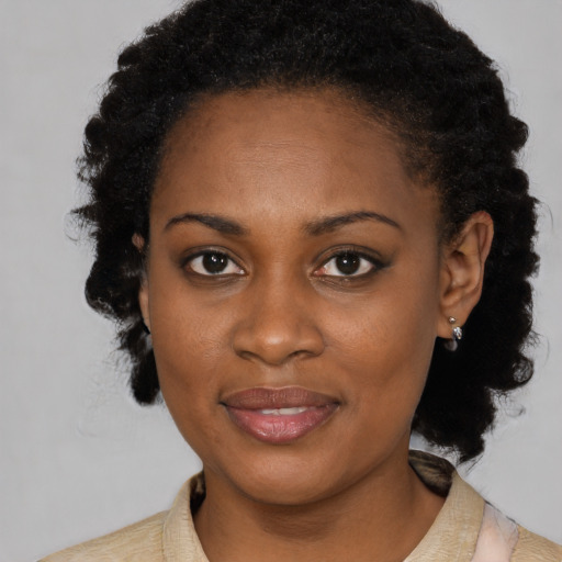Joyful black young-adult female with medium  black hair and brown eyes