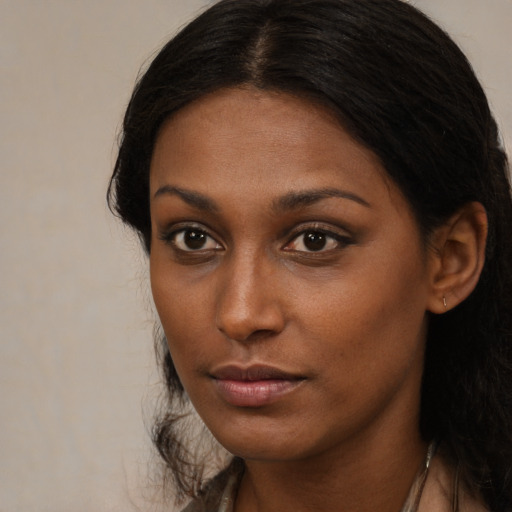Neutral black young-adult female with long  brown hair and brown eyes