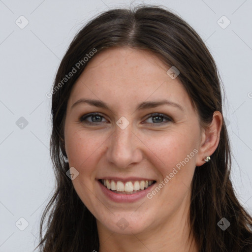 Joyful white young-adult female with long  brown hair and grey eyes